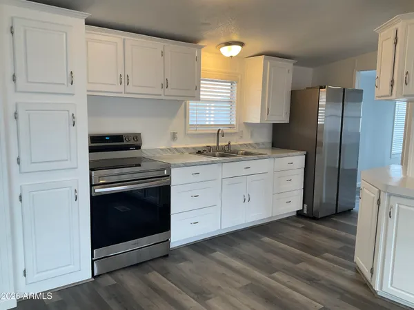 a kitchen with stainless steel appliances granite countertop a stove a refrigerator and cabinets