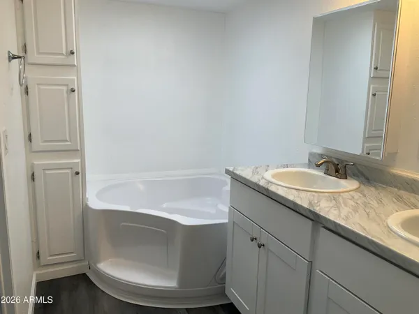 a bathroom with a granite countertop sink a toilet and bathtub