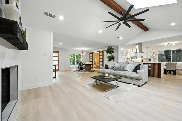 a kitchen with granite countertop a sink a stove refrigerator and cabinets