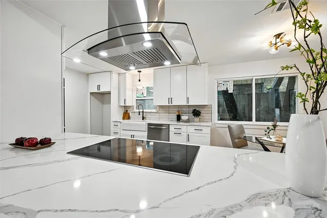 a kitchen with a sink stove and cabinets
