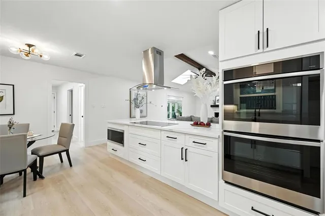 a living room with furniture and floor to ceiling windows