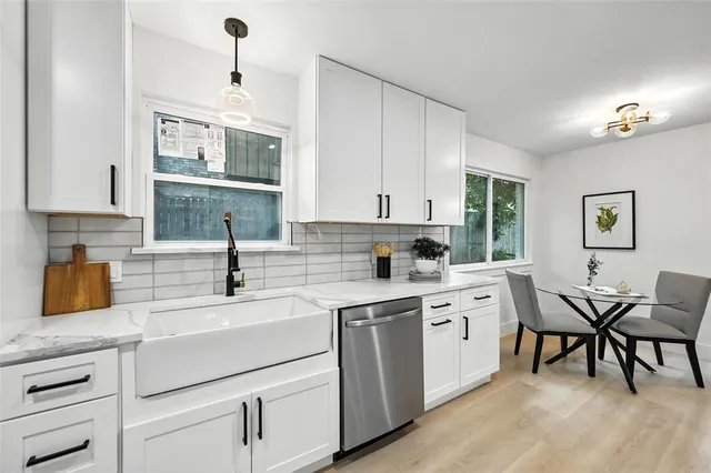 a bedroom with a bed a couch and a chandelier