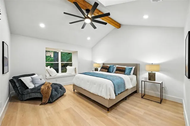 a bathroom with a white bath tub a shower and a sink