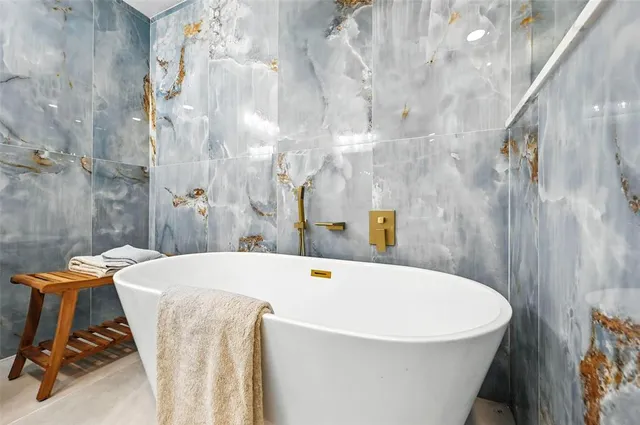 a view of a livingroom with a ceiling fan wooden floor and window