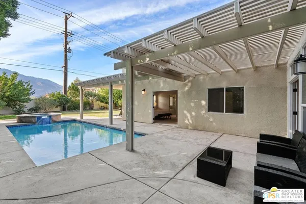 a swimming pool with outdoor seating and yard