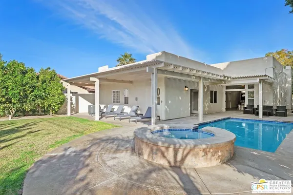 a view of a house with swimming pool and porch