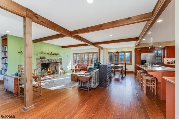 a bathroom with a toilet a sink a mirror a window and vanity