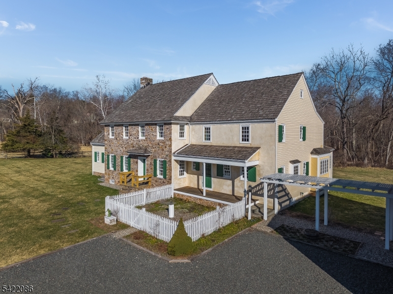 348 Rosemont Ringoes Road Stockton, NJ 08559 - Photo 45 of 49 a front view of a house with a yard table and chairs