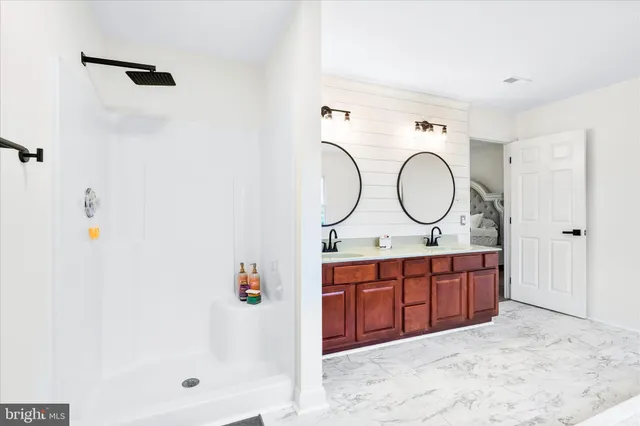 a view of a cabinet with a sink and a mirror