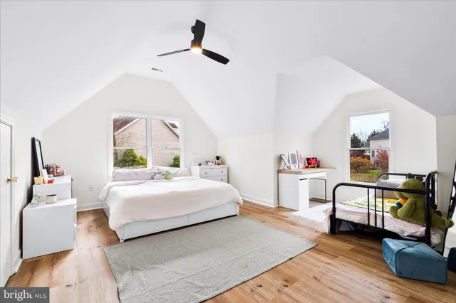 a bedroom with a bed and a large mirror