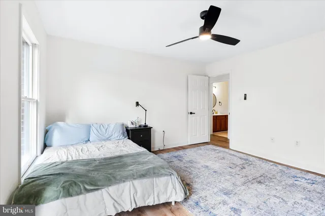 a bedroom with a bed and ceiling fan