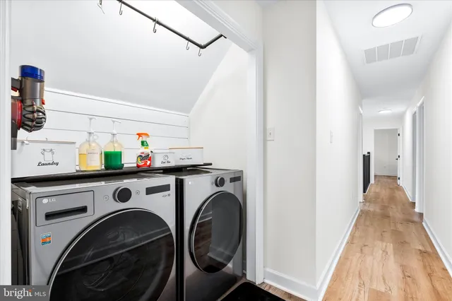 a view of washer and dryer with kitchen in the background