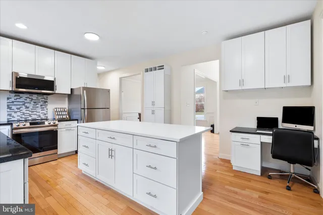 a kitchen with a stove a sink and a refrigerator