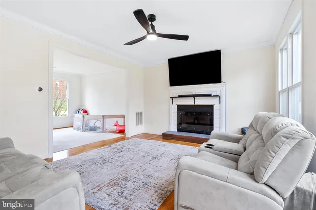 a living room with furniture fireplace and flat screen tv