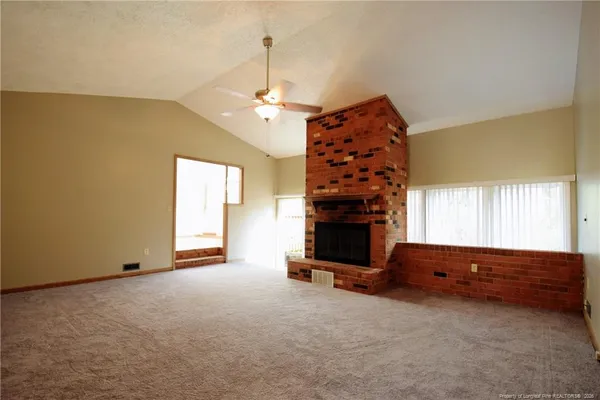 a view of an empty room with a ceiling fan