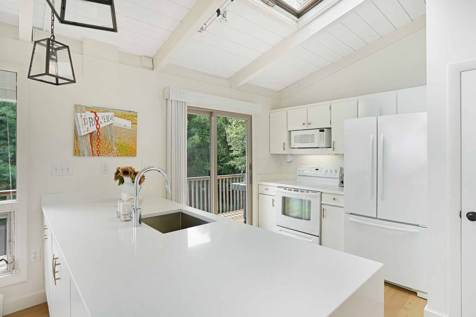 25 Down Harbor Road Edgartown, MA 02539 - Photo 16 of 35 a kitchen with stainless steel appliances a refrigerator sink and cabinets