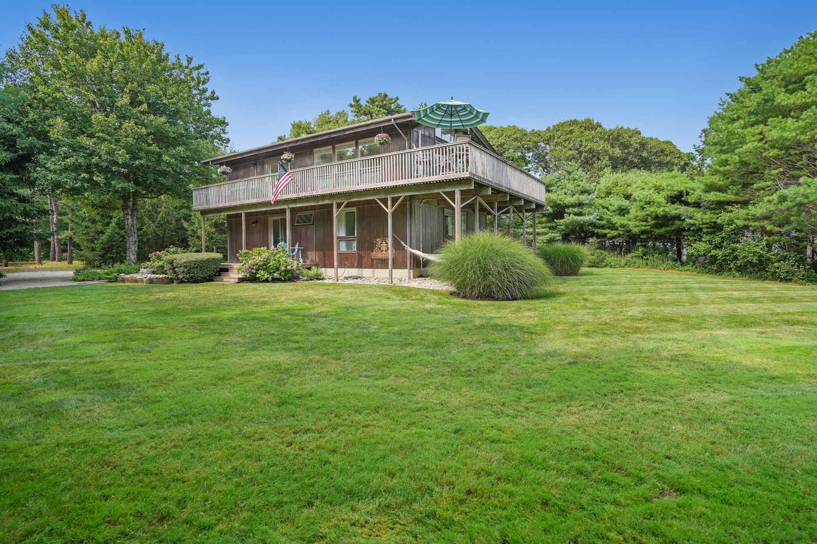 25 Down Harbor Road Edgartown, MA 02539 - Photo 3 of 35 a front view of a house with a garden