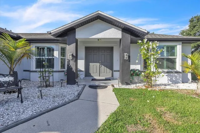 a kitchen with granite countertop white cabinets stainless steel appliances and window