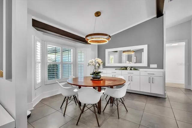 a view of a chairs and table in backyard of the house