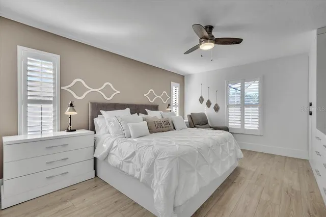 a spacious bedroom with a bed and a window