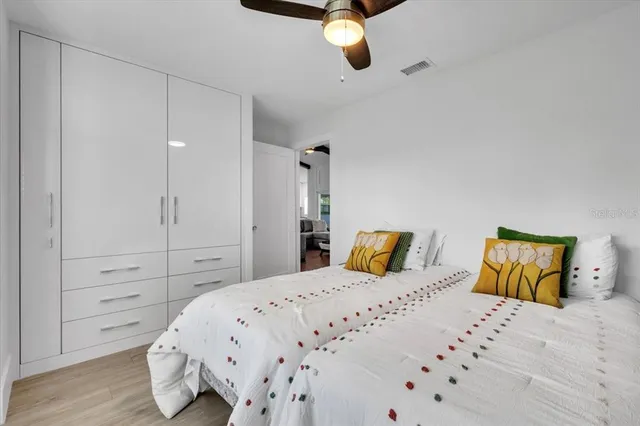 a view of a patio with table and chairs with wooden floor and fence