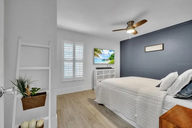 a view of a patio with table and chairs with wooden floor and fence