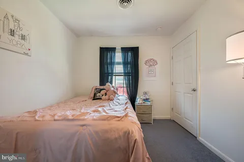 a bed sitting in a bedroom next to a window