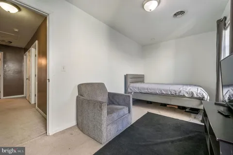 a bedroom with furniture and a chair