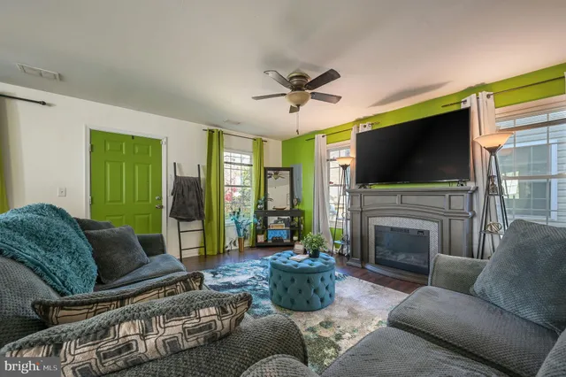 a living room with furniture a fireplace and a flat screen tv