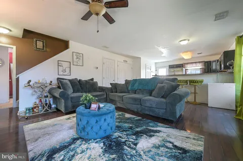 a living room with furniture and kitchen view