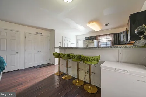 a kitchen with a table chairs refrigerator and microwave