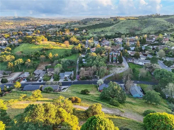 an aerial view of residential houses with outdoor space and swimming pool