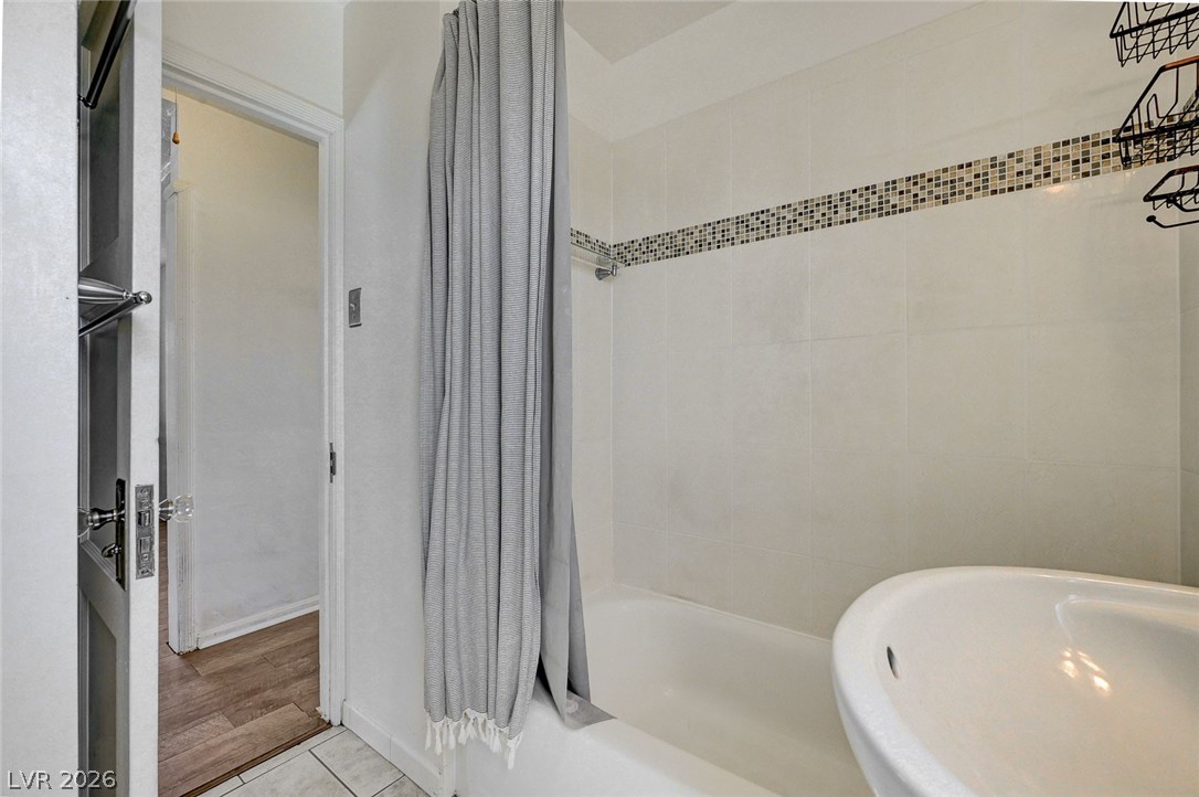 629 L Avenue Boulder City, NV 89005 - Photo 25 of 46 Bathroom with shower / bath combo with shower curtain and light tile patterned flooring