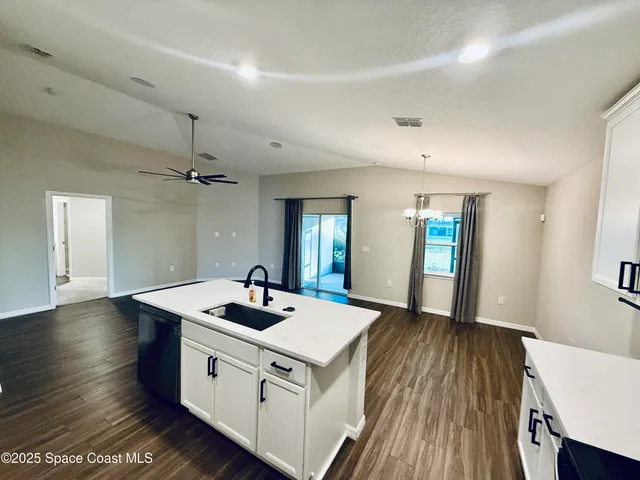 a kitchen with sink stove and refrigerator