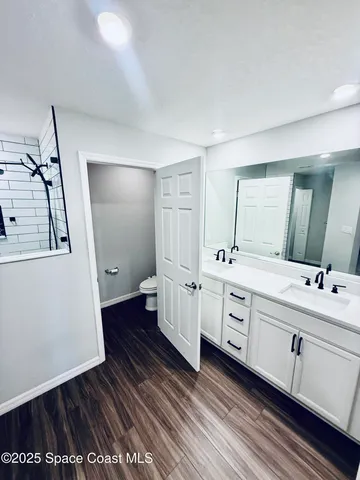 a bathroom with a double vanity sink and a mirror