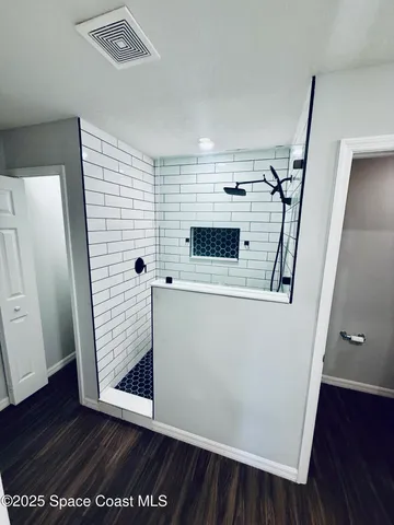 an entryway with wooden floor and hallway