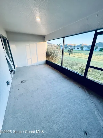 a view of an empty room with a large window