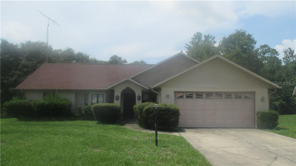 4310 Southwest 142nd Street Road Ocala, FL 34473 - Photo 1 of 1 a front view of a house with a garden