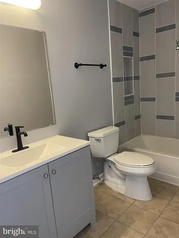 a bathroom with a sink toilet vanity and shower