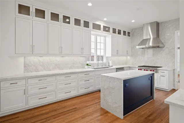 a kitchen with stainless steel appliances granite countertop a sink and a stove