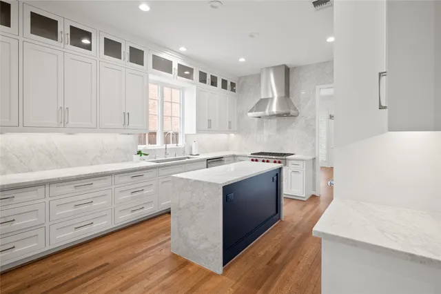 a kitchen with stainless steel appliances sink stove and cabinets