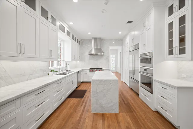 a large kitchen with stainless steel appliances granite countertop a large center island and a sink