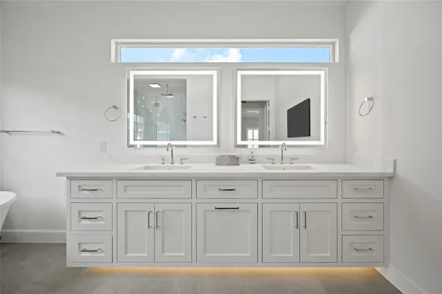 a bathroom with a granite countertop sink mirror and next to a window