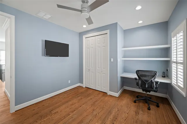a view of a workspace with furniture and a window