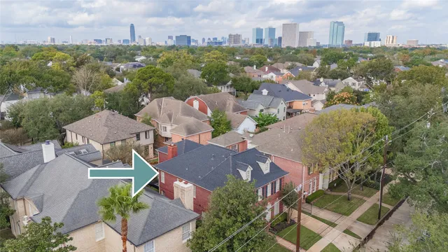 an aerial view of multiple houses with a yard