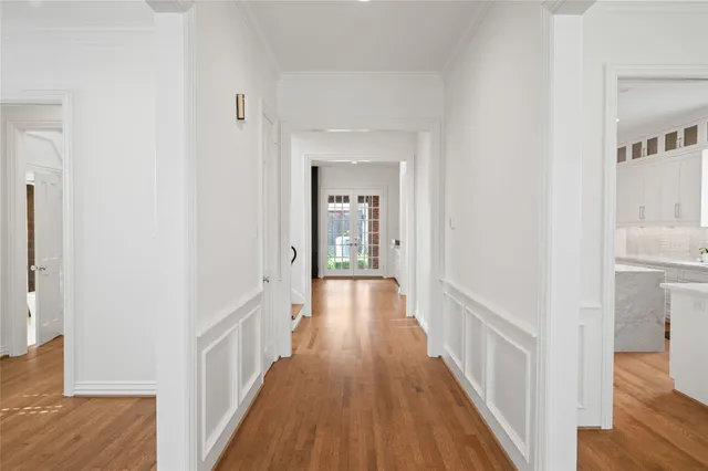 a view of a hallway with wooden floor and entryway