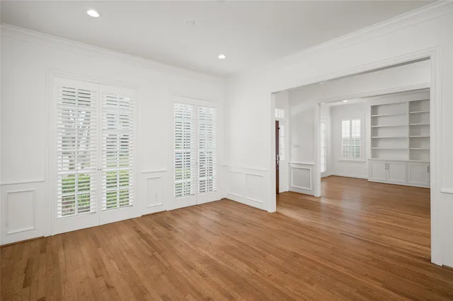 wooden floor in an empty room with a window
