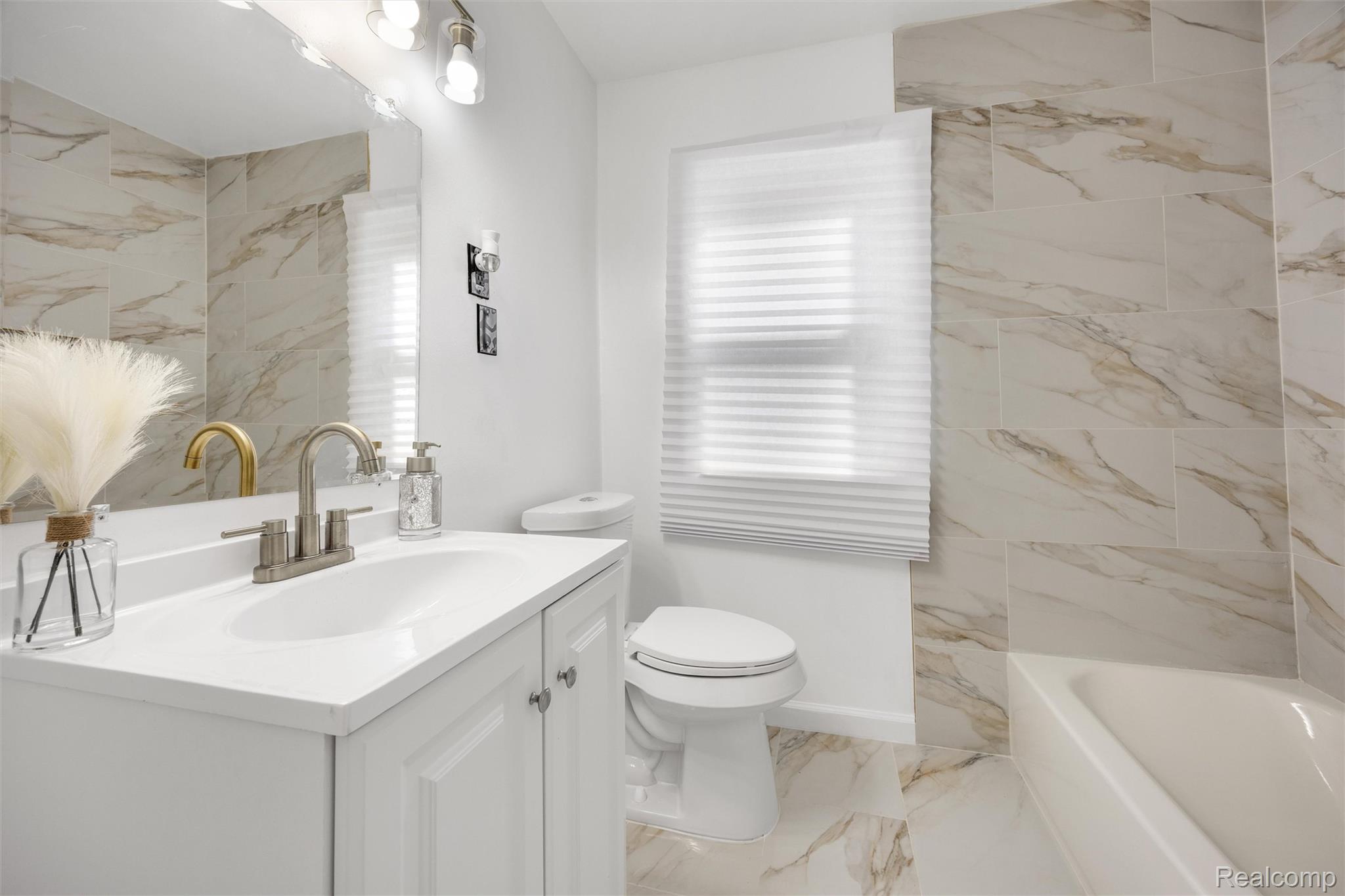 11566 Nottingham Road Detroit, MI 48224 - Photo 12 of 23 White vanity with an integrated sink and brushed nickel faucet