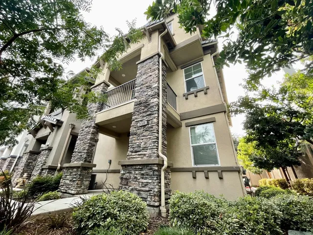 a front view of a house with a street