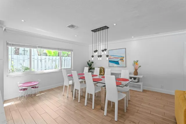a view of a dining table chairs and chandelier